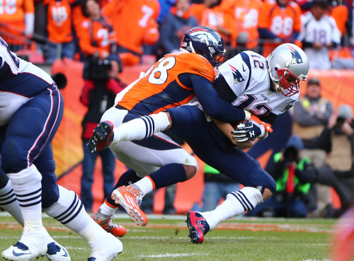 Jan 24, 2016; Denver, CO, USA; New England Patriots quarterback Tom Brady (12) is sacked by Denver Broncos outside linebacker Von Miller (58) in the second half in the AFC Championship football game at Sports Authority Field at Mile High. Mandatory Credit: Mark J. Rebilas-USA TODAY Sports