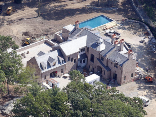 (090514) Tom Brady and Gisele Bundchen's new 14,000 square foot 5 bedroom estate is in the final stages of construction in images taken in Brookline, Massachusetts on September 5, 2014. The sprawling 5.2 acres of property boasts four bathrooms, a motor court, a pool with a Baja shelf, a library with a balcony, a wine cellar and a yoga studio. With the pool full of water and furniture and pottery in the driveway, it appears the move-in date is just around the corner. Photo by FameFlynet