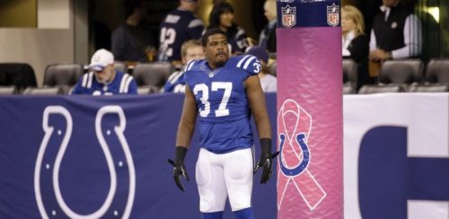 Indianapolis Colts running back Zurlon Tipton warms up as a goal post is wrapped in honor of Breast Cancer Awareness Month before an NFL football game against the New England Patriots in Indianapolis, Sunday, Oct. 18, 2015. (AP Photo/John Minchillo)