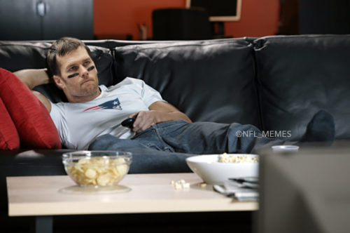 Man on sofa watching television