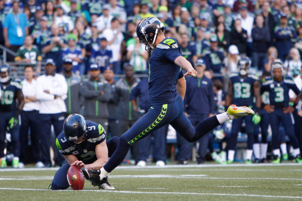 Sep 4, 2014; Seattle, WA, USA; Seattle Seahawks kicker Steven Hauschka (4) kicks a field goal out of the hold by punter Jon Ryan (9) during the first quarter against the Green Bay Packers at CenturyLink Field. Mandatory Credit: Joe Nicholson-USA TODAY Sports