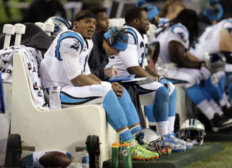 Carolina Panthers quarterback Cam Newton, left, looks on from the bench in the second half of an NFL football game against the Seattle Seahawks, Sunday, Dec. 4, 2016, in Seattle. The Seahawks won 40-7. (AP Photo/Stephen Brashear)