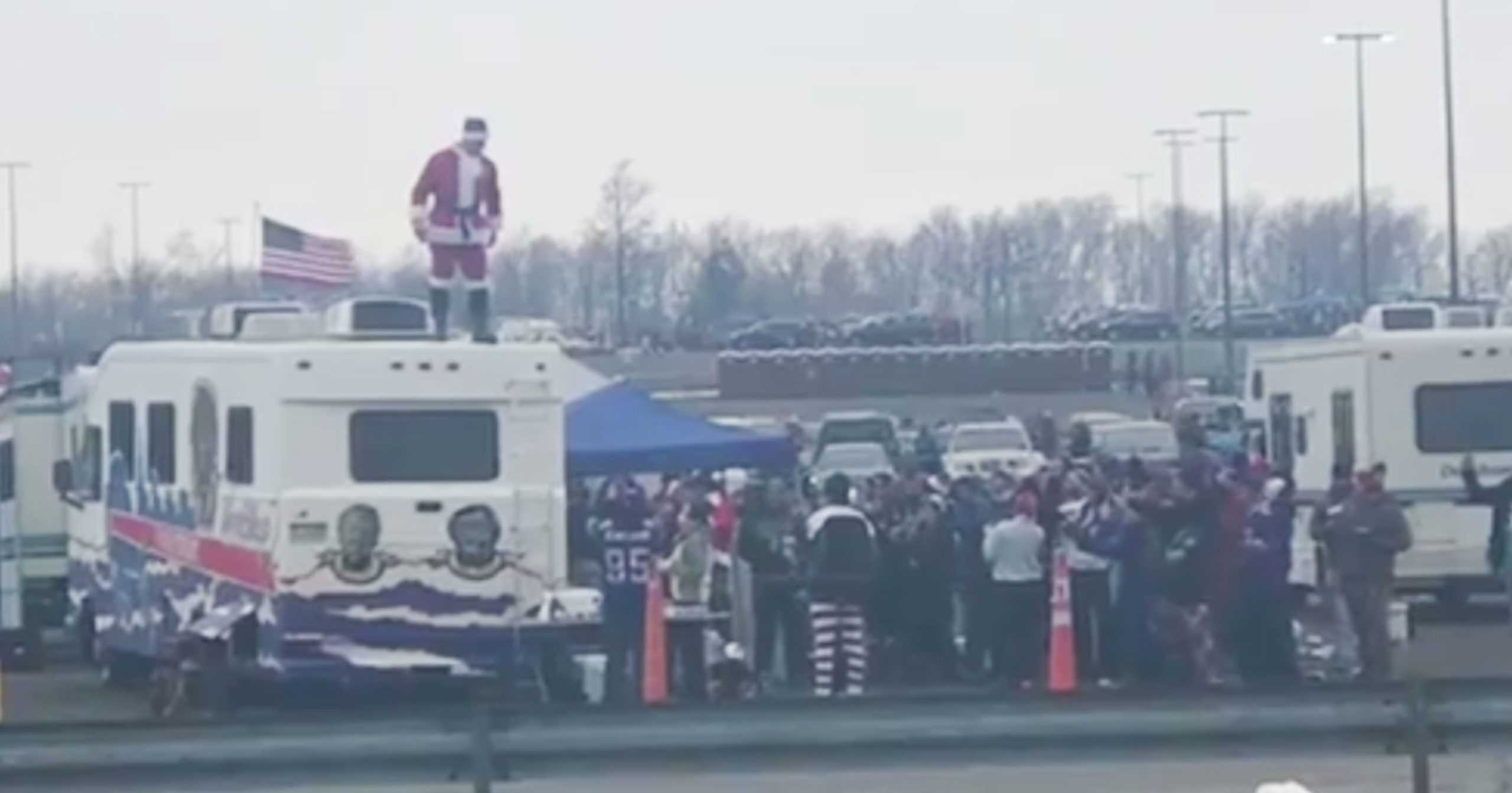 Bills Fan Dressed As Santa Jumps Off Top of RV To Smash Table