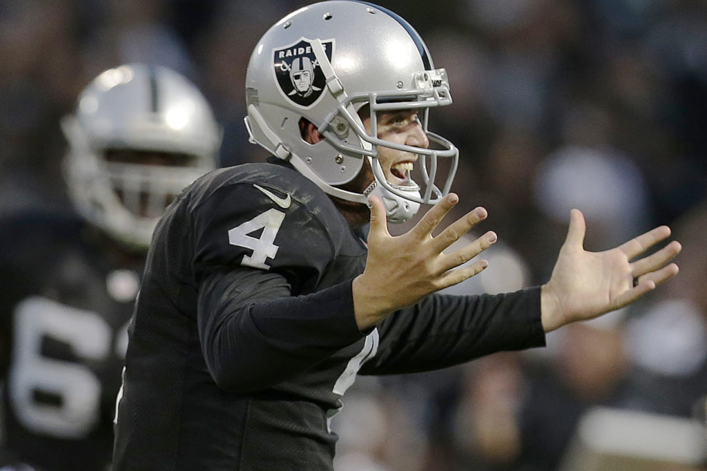 Oakland Raiders quarterback Derek Carr, right, celebrates after throwing a 20-yard touchdown pass to Mychal Rivera against the Seattle Seahawks during the first half of an NFL preseason football game in Oakland, Calif., Thursday, Aug. 28, 2014. (AP Photo/Marcio Jose Sanchez)