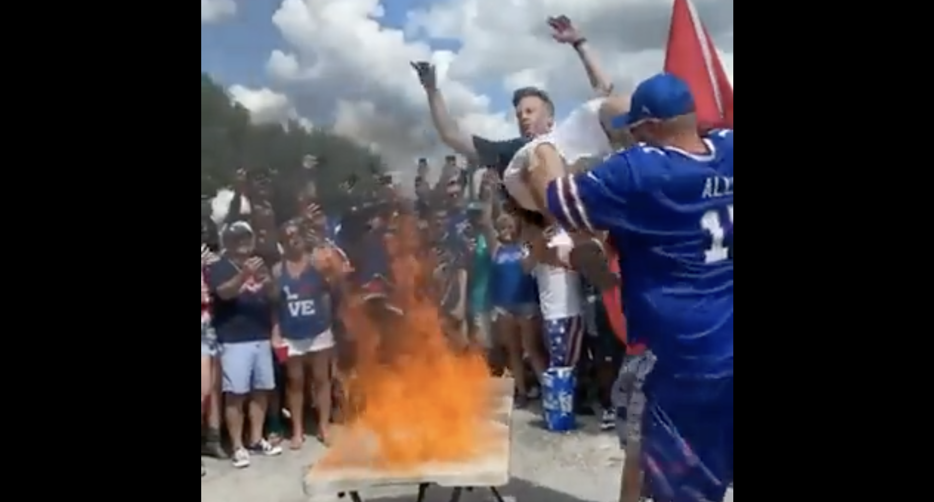 Bills fan jumps on flaming table, predictably catches on fire